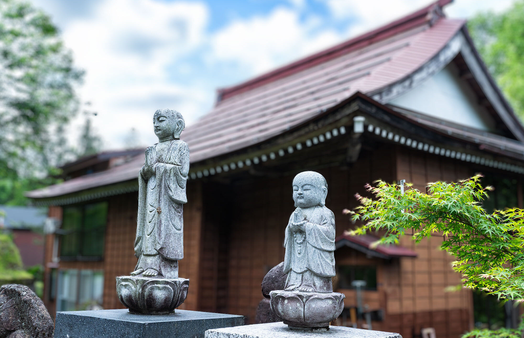 青空のもと慶學寺境内にある永代供養墓および無縁供養墓